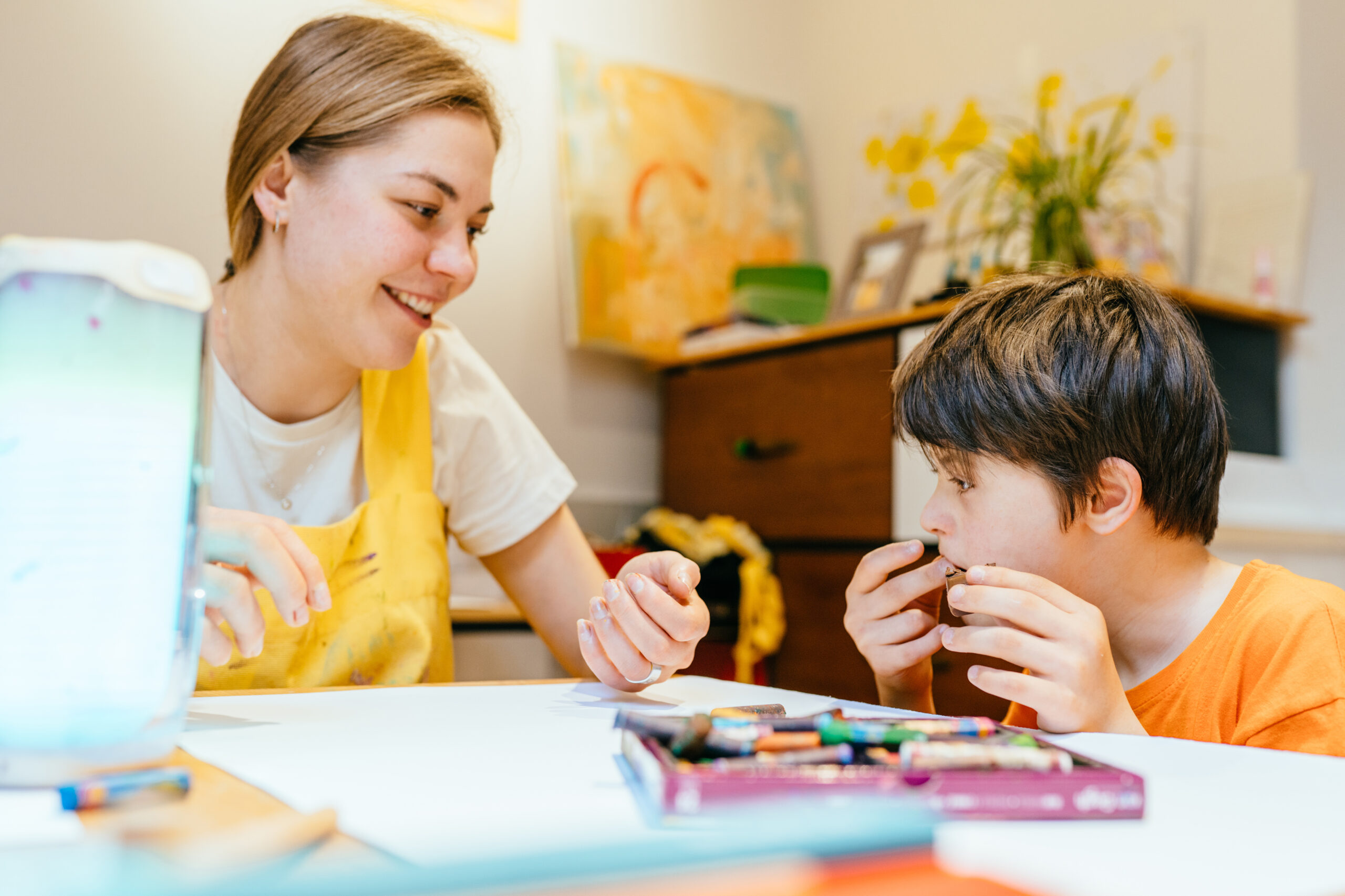 Nursery,teacher,sitting,with,boy,child,down,syndrome,communicate,in