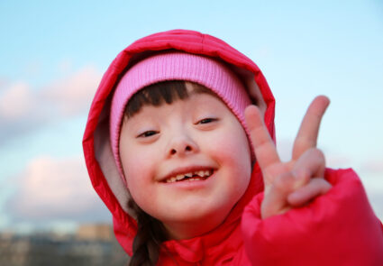 Young,girl,smiling,on,background,of,the,blue,sky
